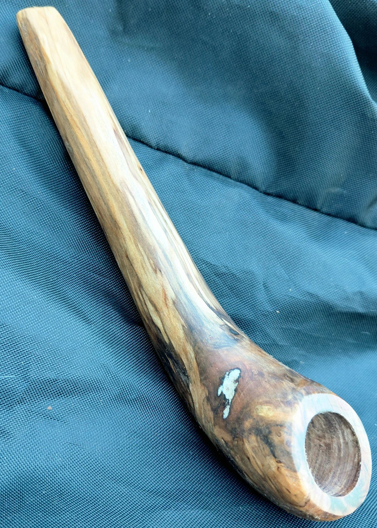 Long-stemmed wooden pipe with a white stone inlay