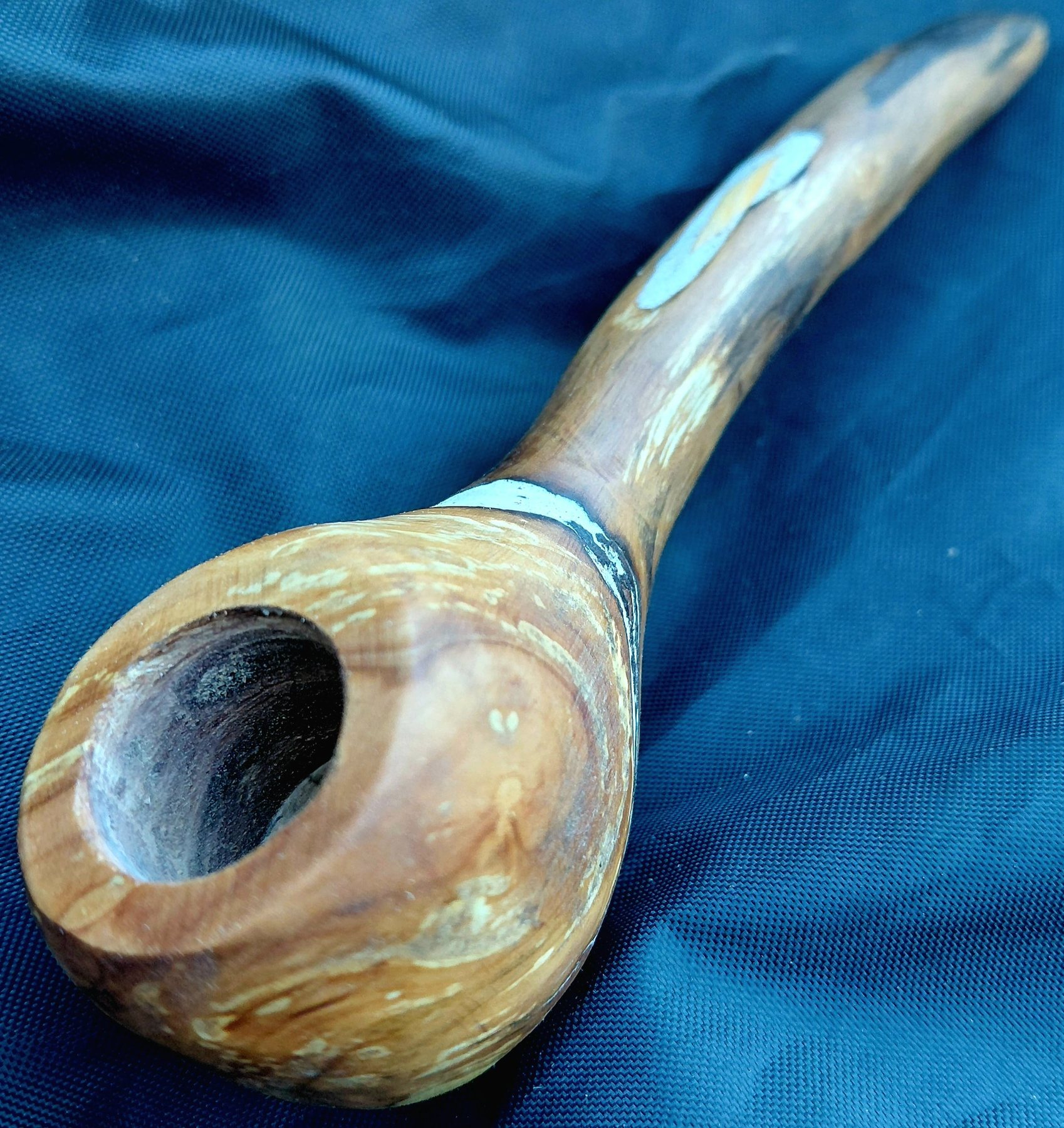 Curved wooden pipe with silver and stone inlays